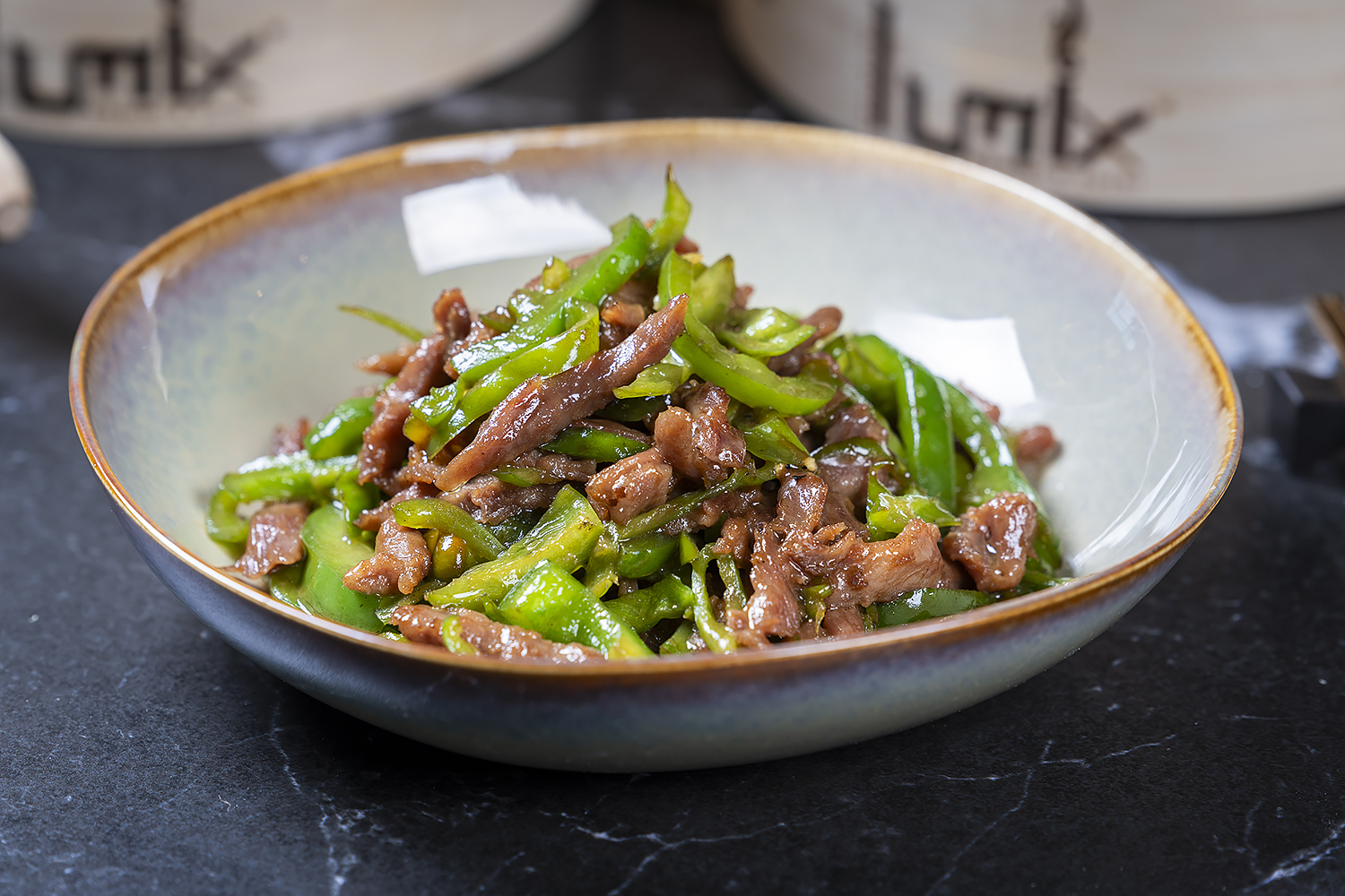 Stir-fried beef with green peppers served in a bowl