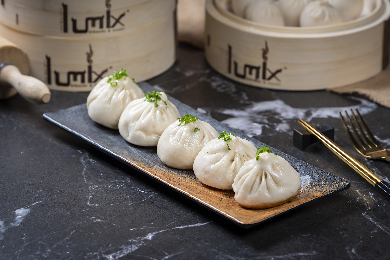 Steamed soup dumplings served on a traditional plate