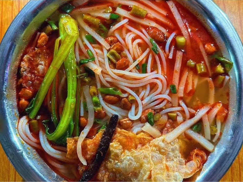 Liuzhou-Spicy-Rice-Noodle-Chinese-Noodle-Restaurant-Luosifen–Spicy-Liuzhou-Rice-Noodles-Chicago Liuzhou rice noodles (Luosifen) with spicy broth, bamboo shoots, peanuts, and herbs.