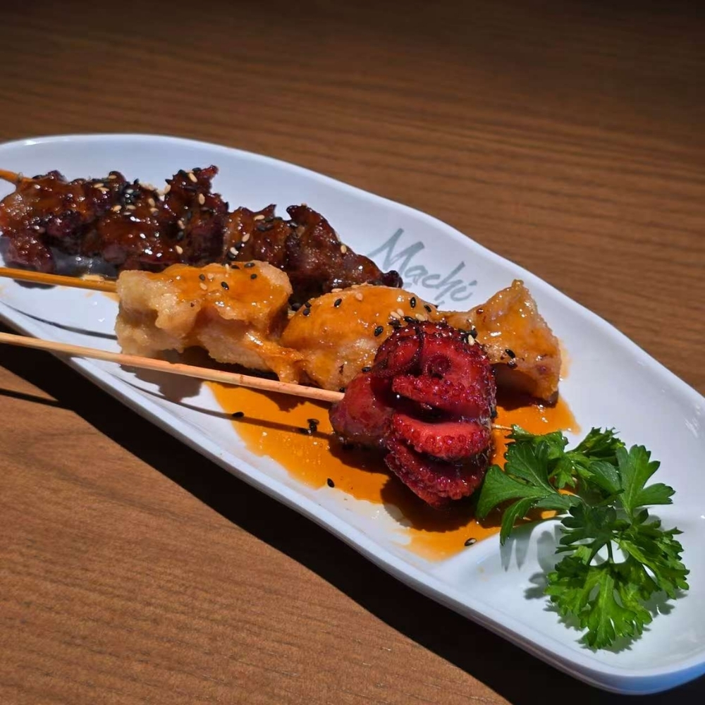 Assorted yakitori skewers with sesame and teriyaki sauce at Machi Sushi, an Asian Restaurant in Houston