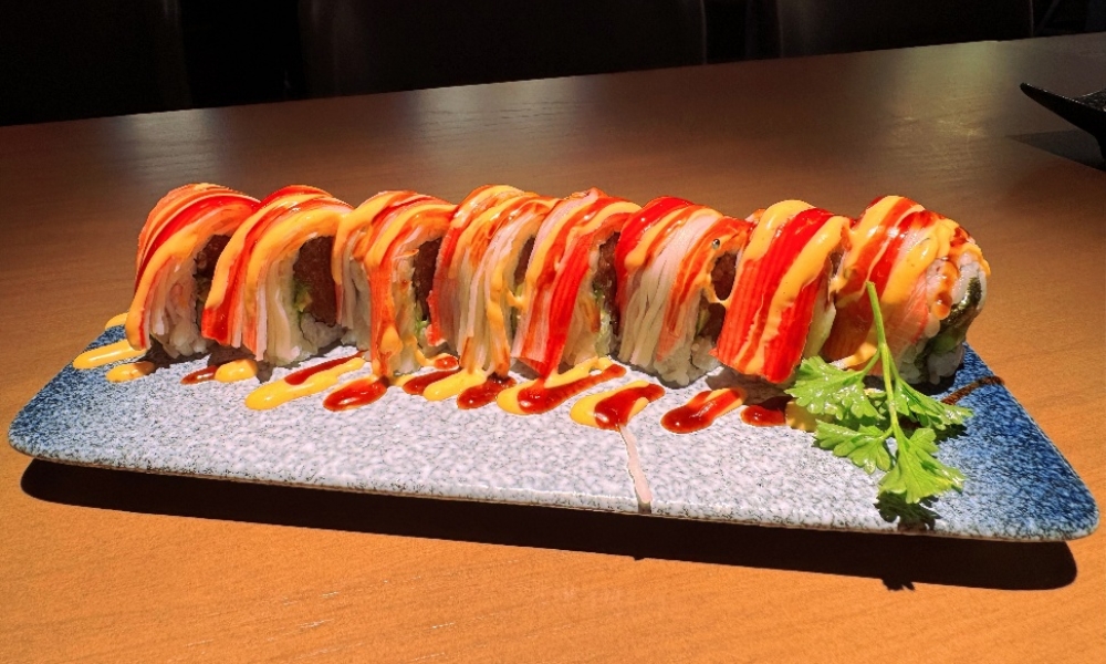 Crab stick sushi roll drizzled with two sauces at Machi Sushi, an Asian Restaurant in Houston