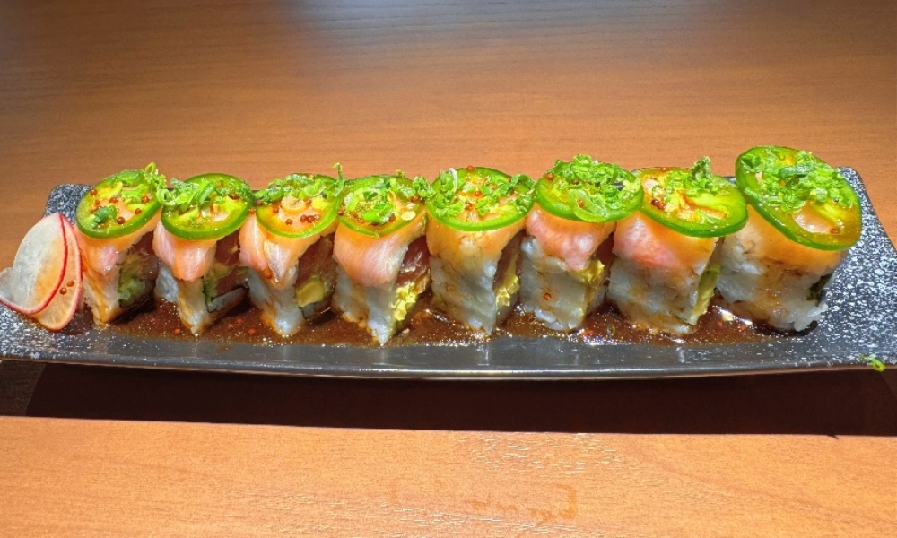 Salmon sushi roll with jalapeño slices and spicy sauce at Machi Sushi, an Asian Restaurant in Houston
