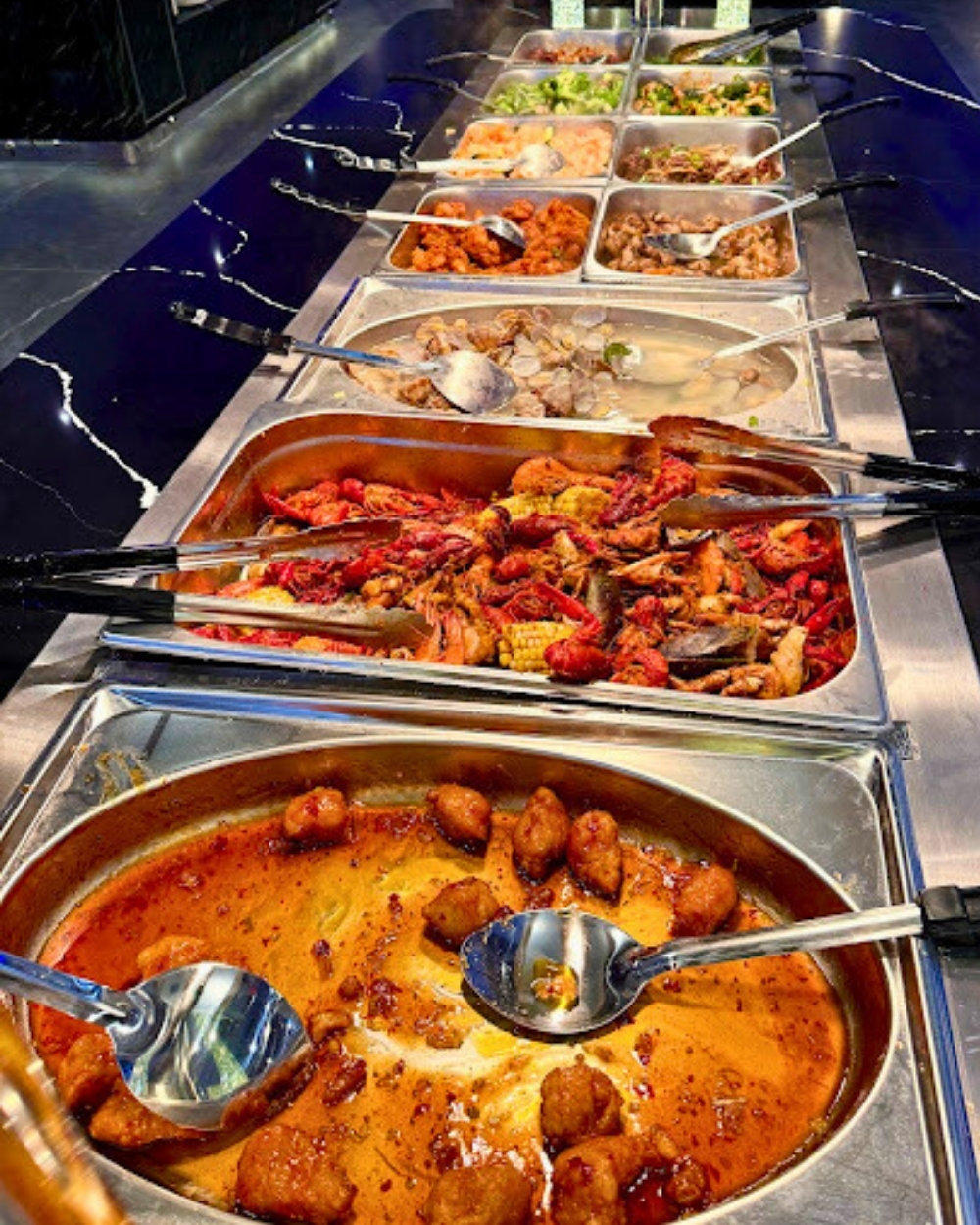 Crawfish boil and assorted hot dishes at Madness Buffet, a Buffet Restaurant in Pompano Beach
