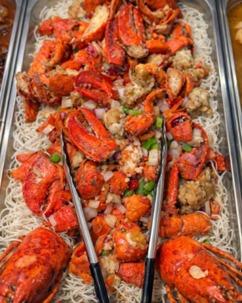 Lobster pieces served over crispy noodles at Madness Buffet, a Buffet Restaurant in Pompano Beach