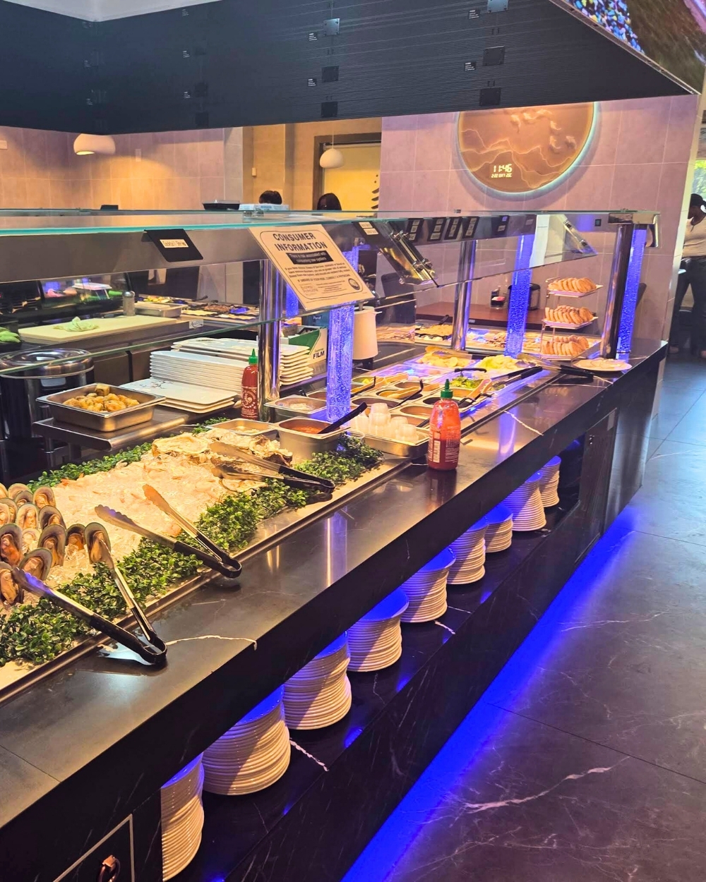 Seafood and hot food buffet station with fresh oysters at Madness Buffet, a Buffet Restaurant in Pompano Beach