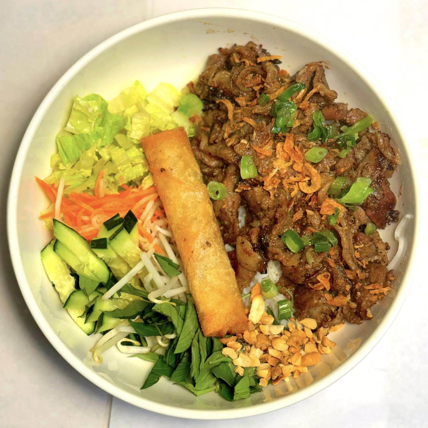 Magnolia-Pho-Vietnamese-Restaurant-Vietnamese-Bowl-with-Grilled-Meat-and-Egg-Roll-Seattle Vietnamese bowl with grilled meat, egg roll and fresh veggies at Magnolia Pho, a Vietnamese Restaurant in Seattle