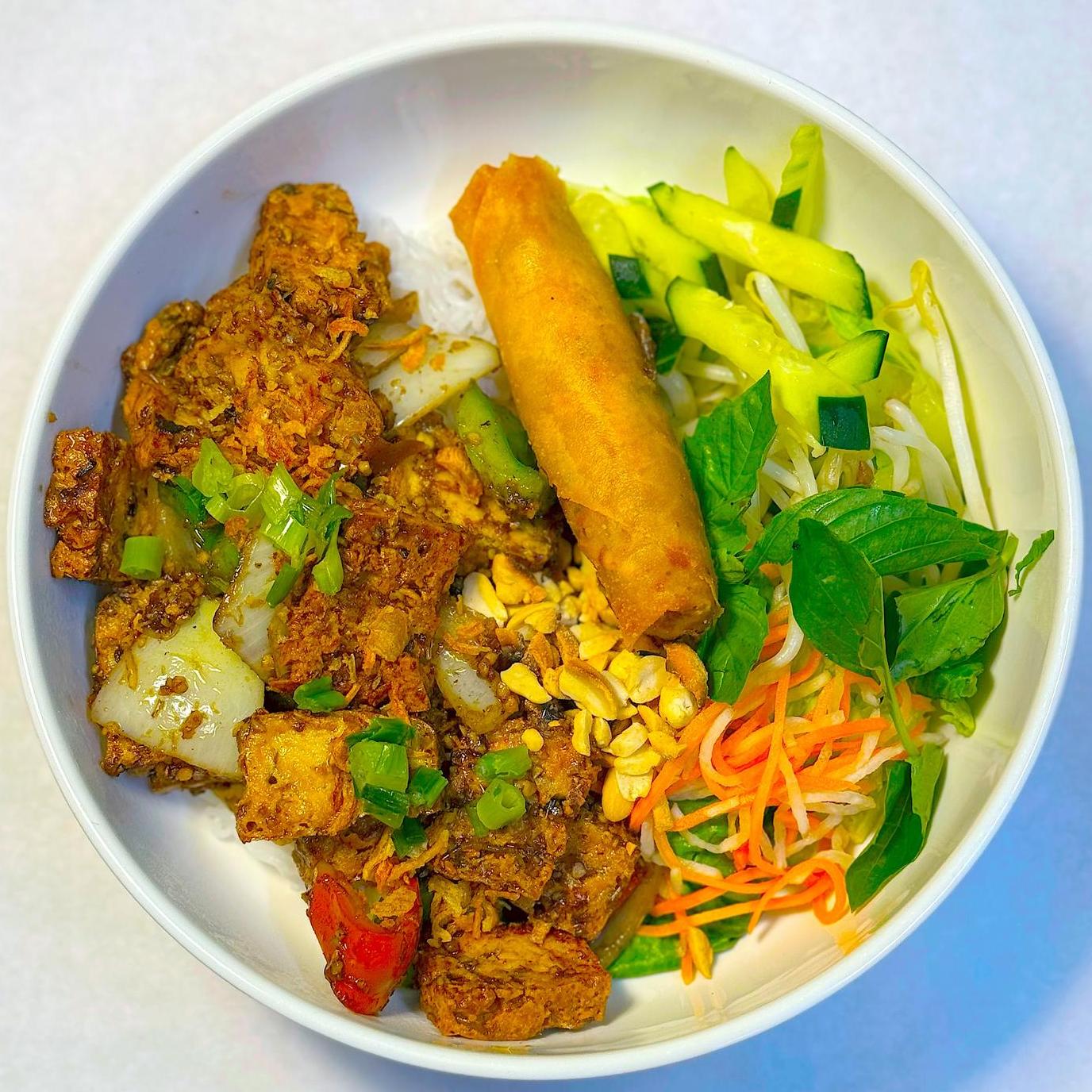 Magnolia-Pho-Vietnamese-Restaurant-Curry-Tofu-Vermicelli-Bowl-with-Egg-Roll-Seattle Curry tofu vermicelli bowl with egg roll and fresh veggies at Magnolia Pho, a Vietnamese Restaurant in Seattle