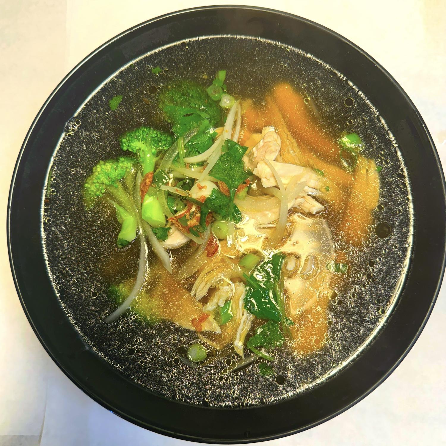 Magnolia-Pho-Vietnamese-Restaurant-Chicken-Noodle-Soup-with-Vegetables-Seattle Chicken noodle soup with broccoli and fresh herbs at Magnolia Pho, a Vietnamese Restaurant in Seattle