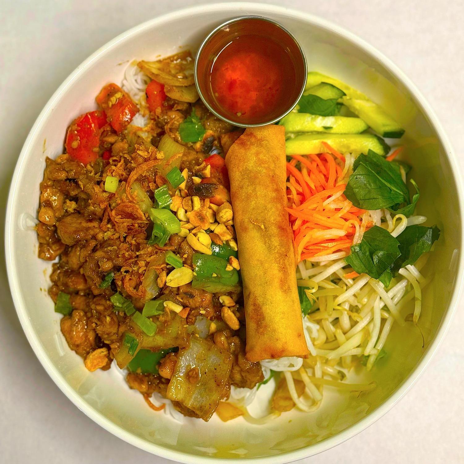 Curry chicken vermicelli bowl with egg roll and veggies at Magnolia Pho, a Vietnamese Restaurant in Seattle