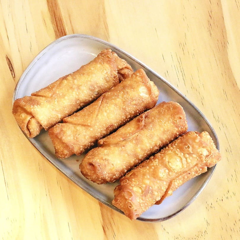 Crispy golden egg rolls on a plate at Main Garden, a Chinese Fusion Restaurant in Passaic