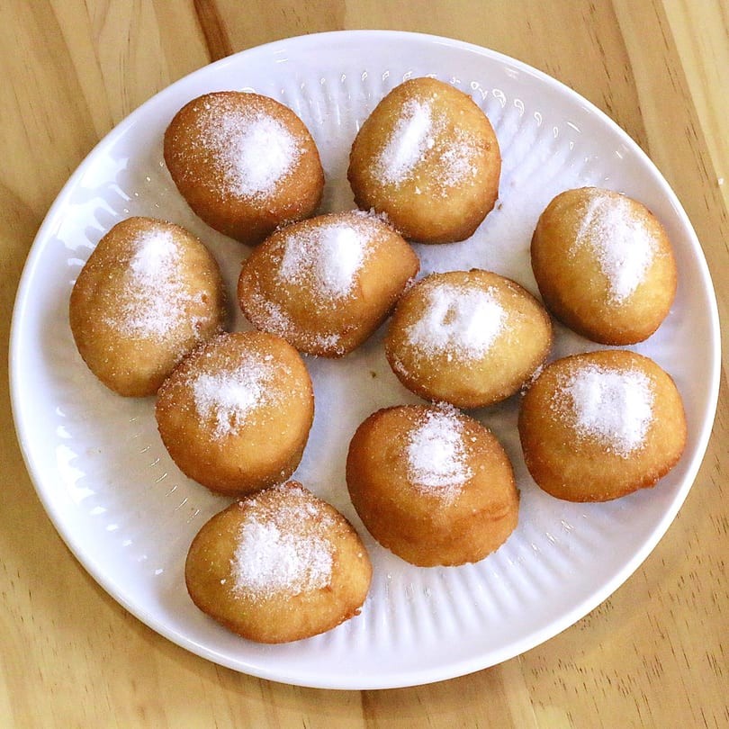 Powdered sugar-dusted fried dough balls on a plate at Main Garden, a Chinese Fusion Restaurant in Passaic