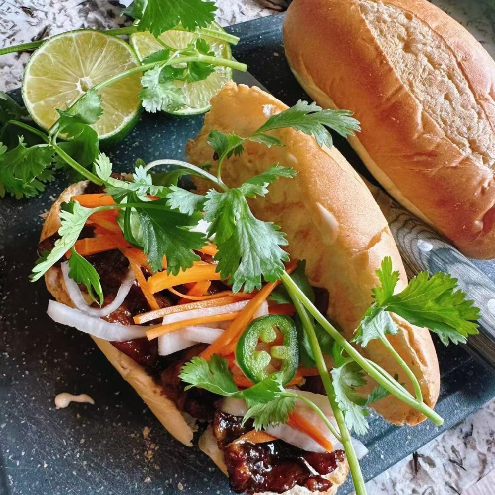 Mama-Hong’s-Pho-&-Bistro-Vietnamese-Restaurant-Banh-Mi-Mustang A delicious banh mi sandwich with meats, veggies, and cilantro at Mama Hong's Pho & Bistro, a Vietnamese Restaurant in Mustang.