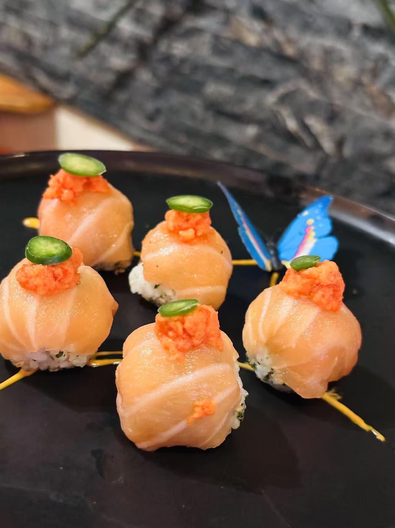 Salmon Nigiri Balls Salmon - topped nigiri with jalapeno and sauce at Masa Sushi, a Japanese restaurant in Somerville
