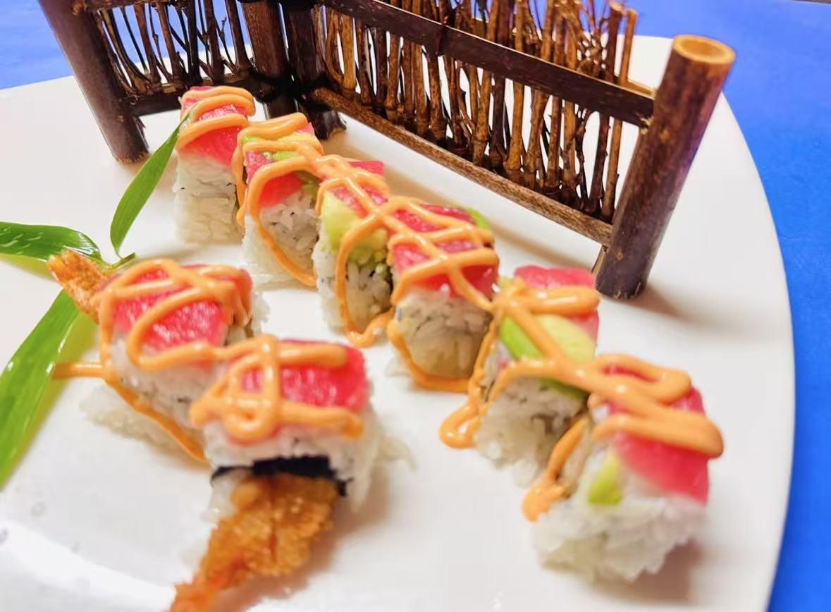 Tuna Avocado Rolls Sushi rolls with tuna, avocado, and drizzled sauce