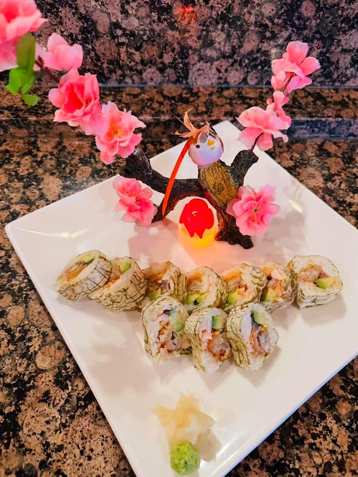 Themed Sushi Set Creative sushi rolls with floral decor and cute figurine at Masa Sushi, a Japanese restaurant in Somerville