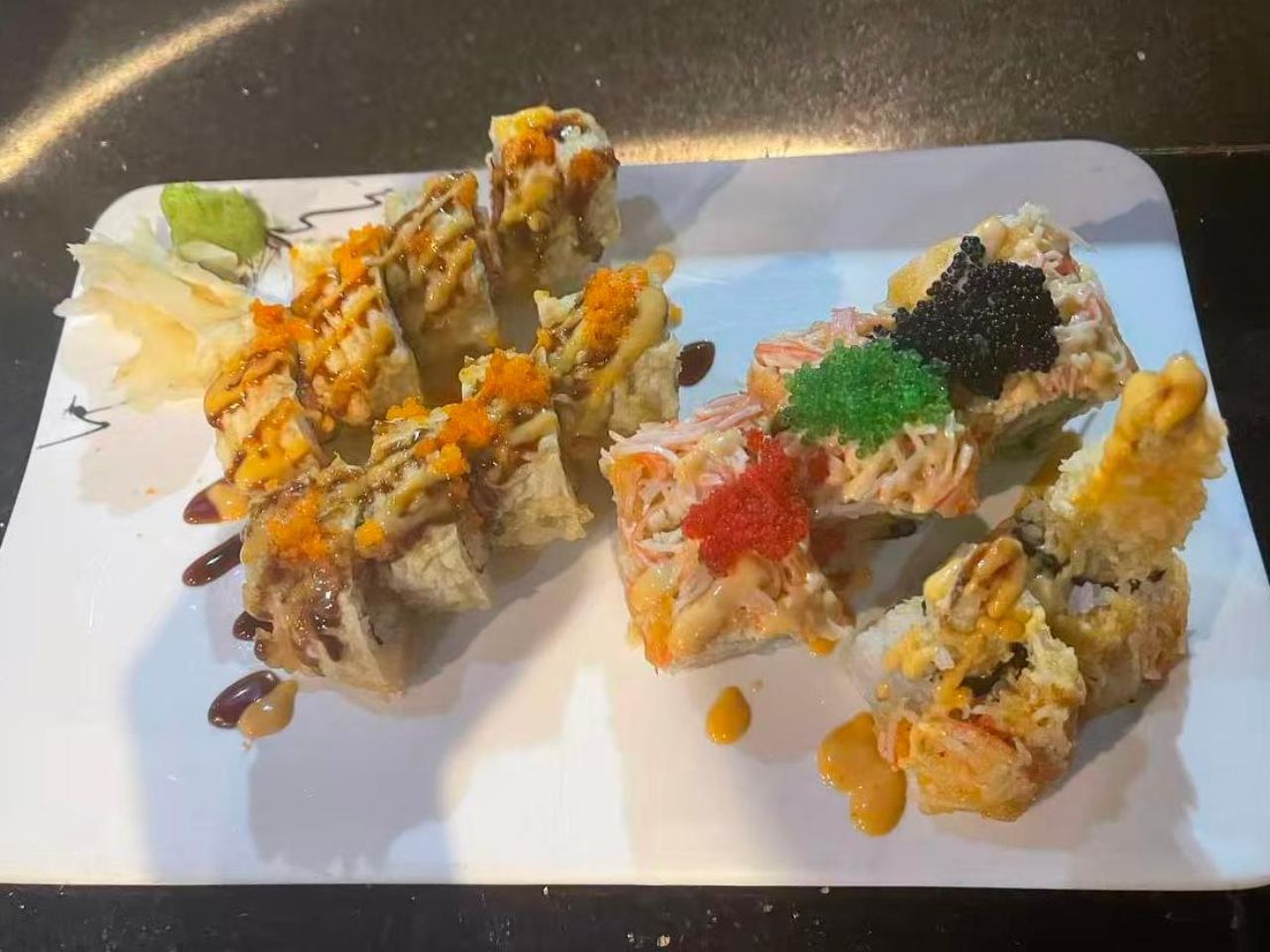 Assorted sushi rolls with sauces and toppings like fish roe at Masa Sushi & Hibachi, a Japanese Restaurant in Marlboro Township