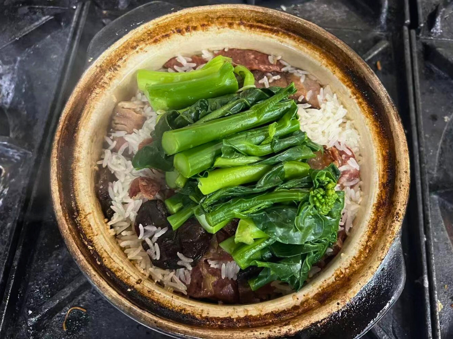 Clay pot rice with sausage and greens at May Mei, a Cantonese Restaurant in Arcadia