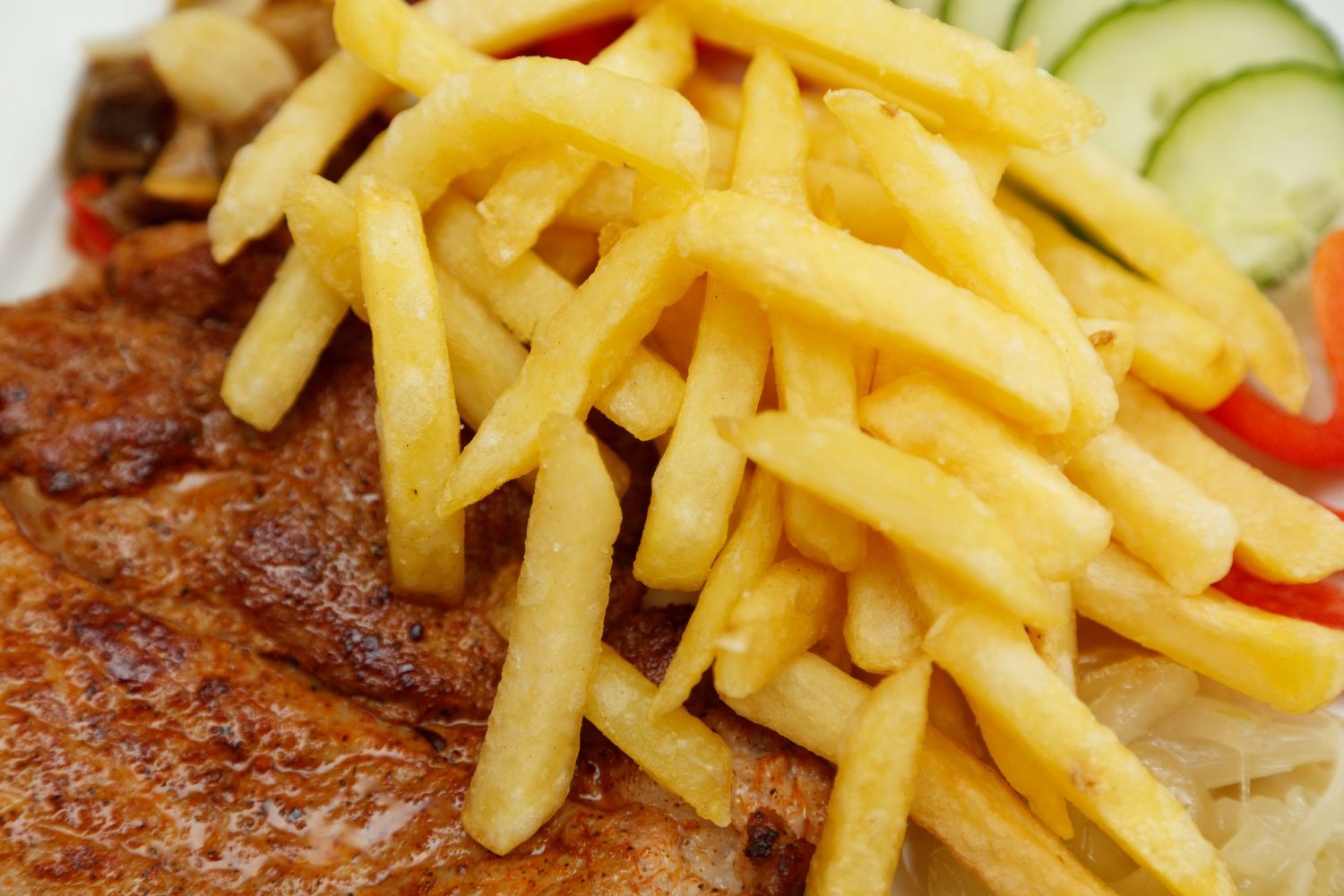 Golden french fries served with grilled meat at MBL & Q Burger, Fried Chicken Shop in Rowland Heights