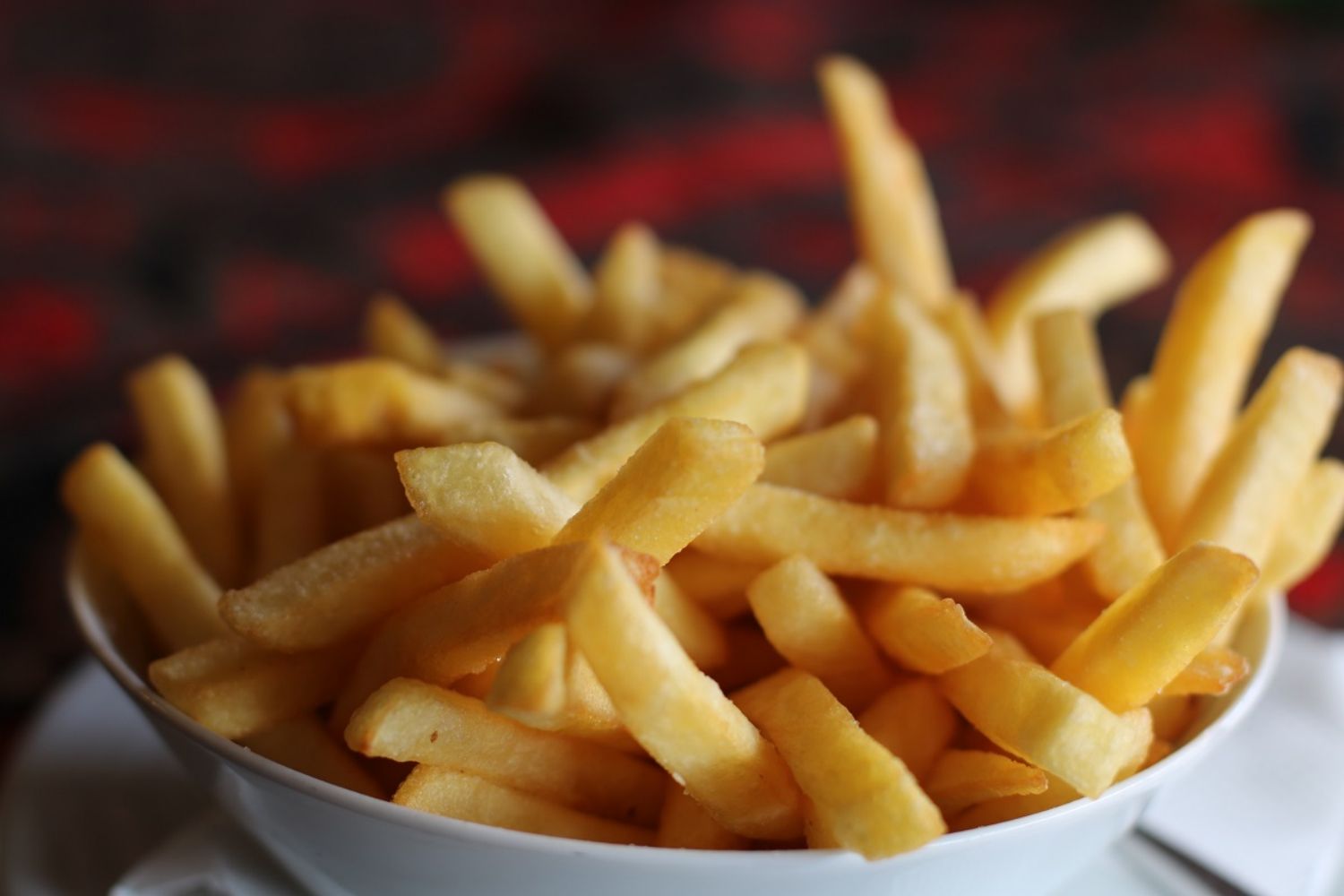 Crispy golden french fries in a white bowl at MBL & Q Burger, Fried Chicken Shop in Rowland Heights