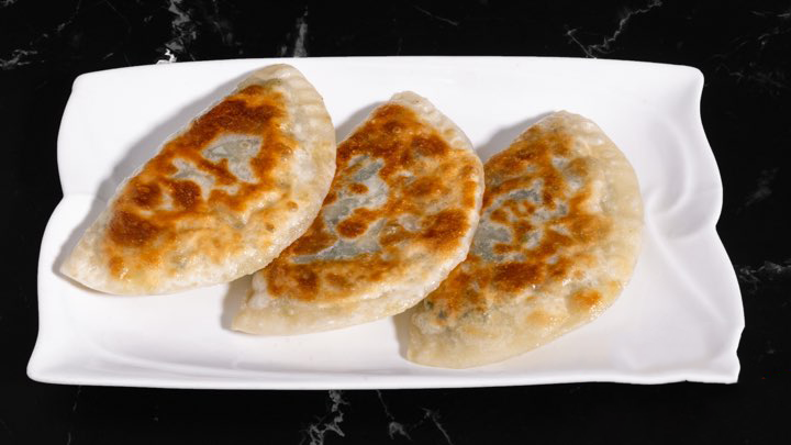 Trio Empanada Pan - fried savory pastries on a plate at M Dumpling, a Chinese restaurant in Fremont