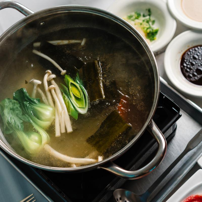 Shabu - shabu broth with bok choy, mushrooms and kelp at Megu French Japanese Cuisine in Fort Worth