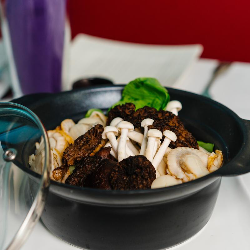 Clay pot dish with assorted mushrooms and greens at Megu French Japanese Cuisine in Fort Worth