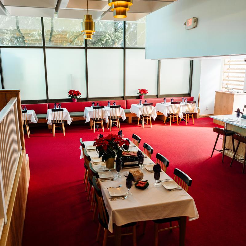 Elegant dining room with red carpet and golden lights at Megu French Japanese Cuisine in Fort Worth