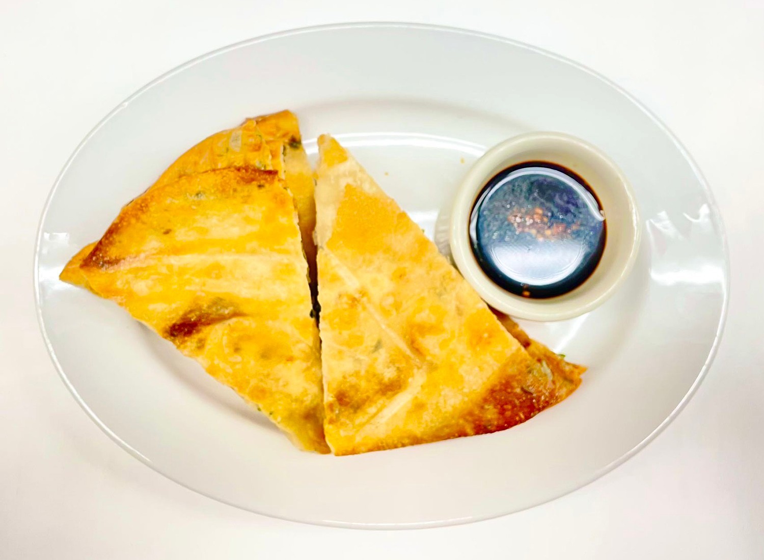 Crispy scallion pancake slices served with dipping sauce at Mei-King Restaurant, a Chinese Restaurant in Pawtucket