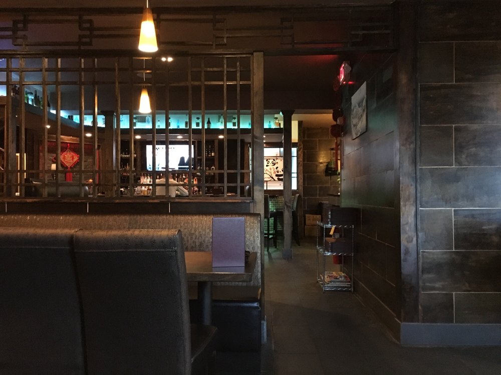 Interior dining room view with booth seating, pendant lights and open bar area of the restaurant at Osaka Asian Bistro, a Asian Restaurant in Merrimac