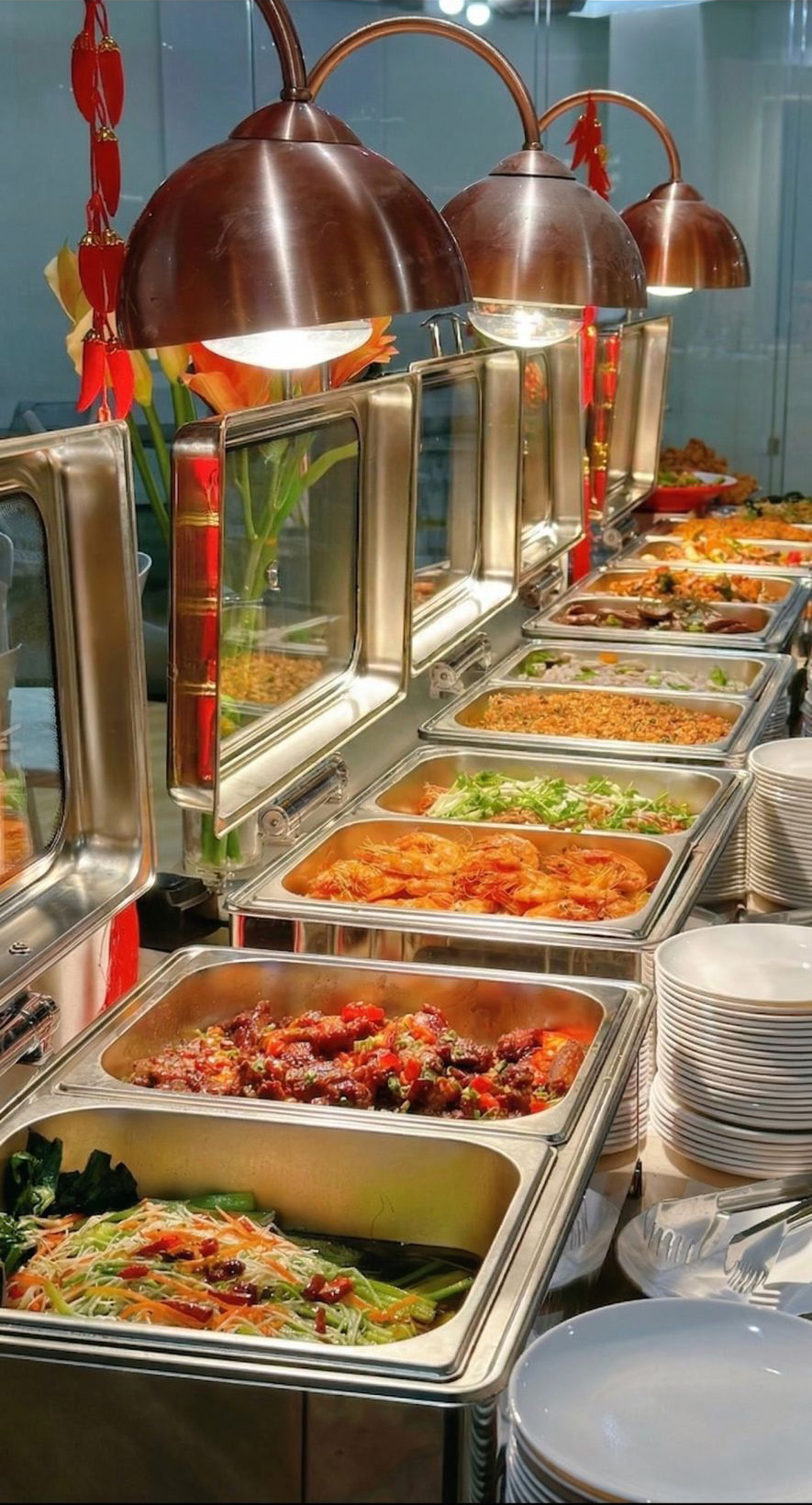 Buffet spread of assorted Asian seafood, stir-fry dishes in stainless steel warmers at Mex Sushi Taco, a Asian restaurant in Place maspeth