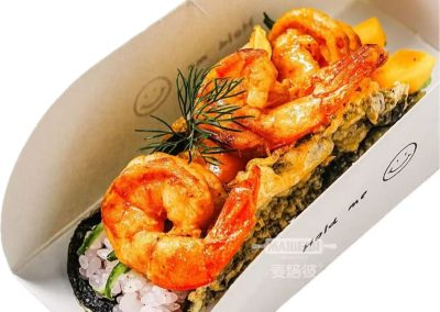 Crispy tempura shrimp sushi taco packed with rice, mango and dill inside paper takeout tray at Mex Sushi Taco, a Asian restaurant in Place maspeth