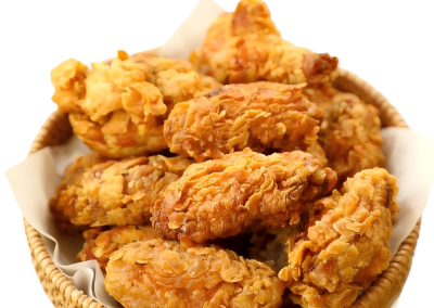Crunchy golden breaded fried chicken drumsticks stacked in lined wicker basket at Mex Sushi Taco, a Asian restaurant in Place maspeth