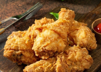 Crispy bone-in fried chicken pieces arranged on rustic wooden serving board at Mex Sushi Taco, a Asian restaurant in Place maspeth
