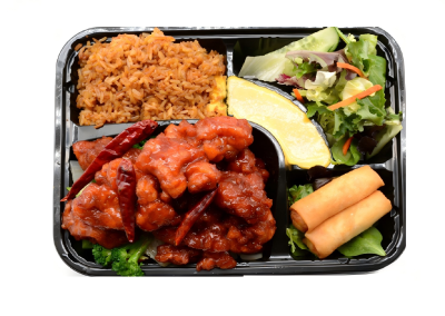 General Tso’s chicken combo with fried rice, salad, spring rolls and fresh pineapple wedge in takeout tray at Mex Sushi Taco, a Asian restaurant in Place maspeth