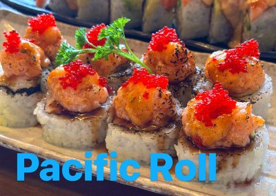 Seared salmon-topped Pacific Roll sushi with tobiko garnish on a ceramic plate at Mex Sushi Taco, a Asian restaurant in Place maspeth