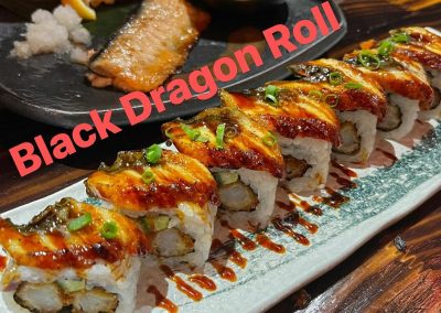 Grilled eel-topped Black Dragon Roll sushi drizzled with dark sauce and scallions at Mex Sushi Taco, a Asian restaurant in Place maspeth