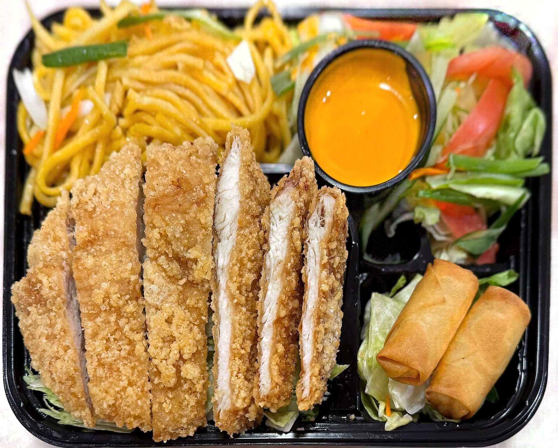 Crispy breaded chicken cutlet combo with noodles, spring rolls, fresh salad and creamy dipping sauce at Mex Sushi Taco, a Asian restaurant in Place maspeth