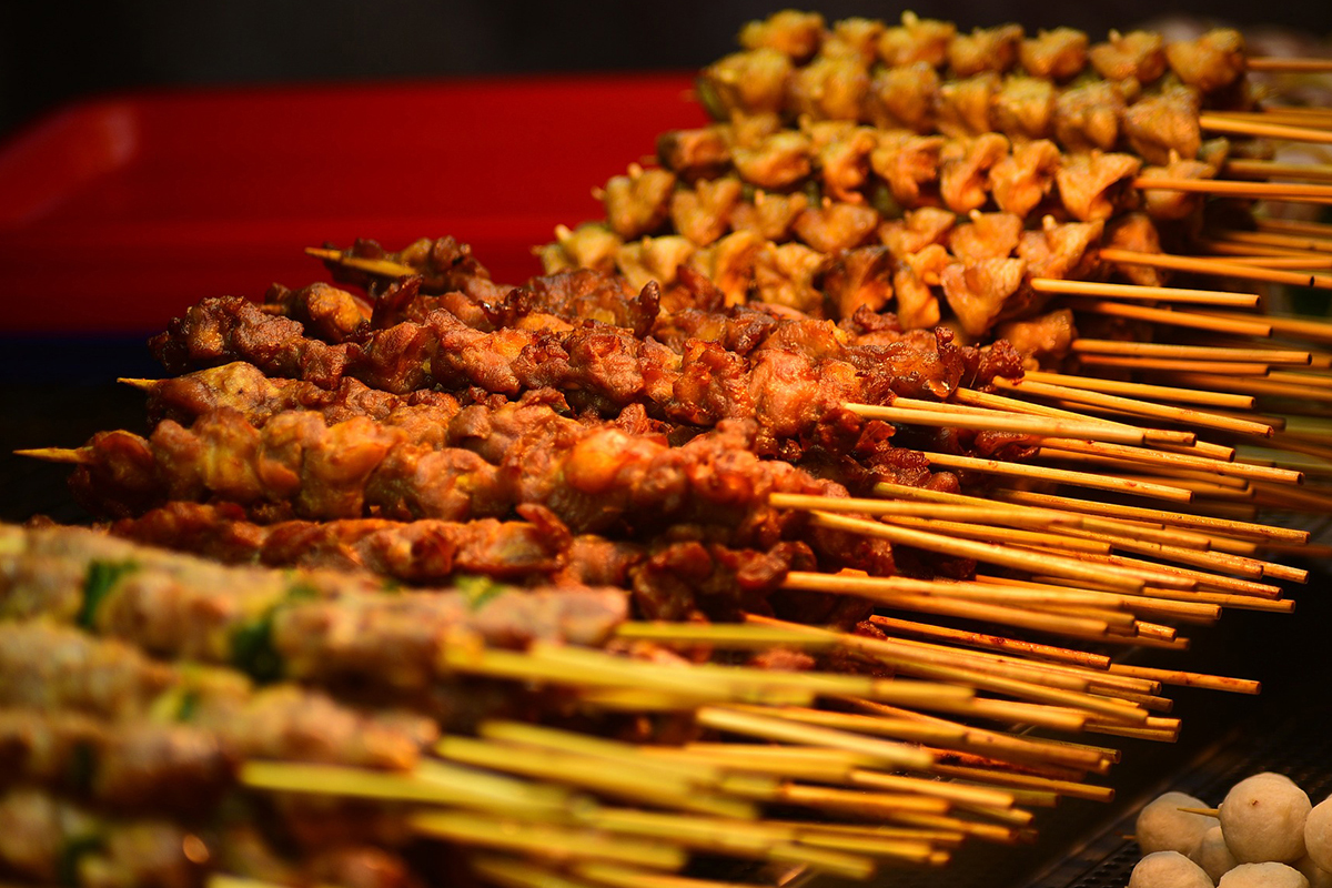 Close-up of various grilled meat and vegetable skewers (on bamboo sticks) arranged in rows at M Bar BBQ，a Barbecue Restaurant in Arcadia