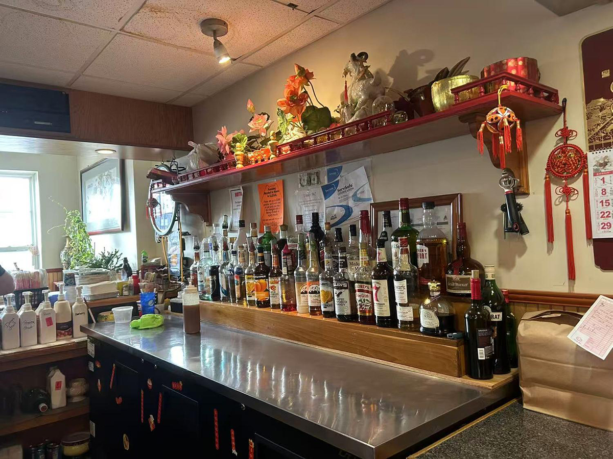 Chinese restaurant bar with liquor bottles and traditional decor at Ming's Garden, a Chinese Restaurant in Bucksport