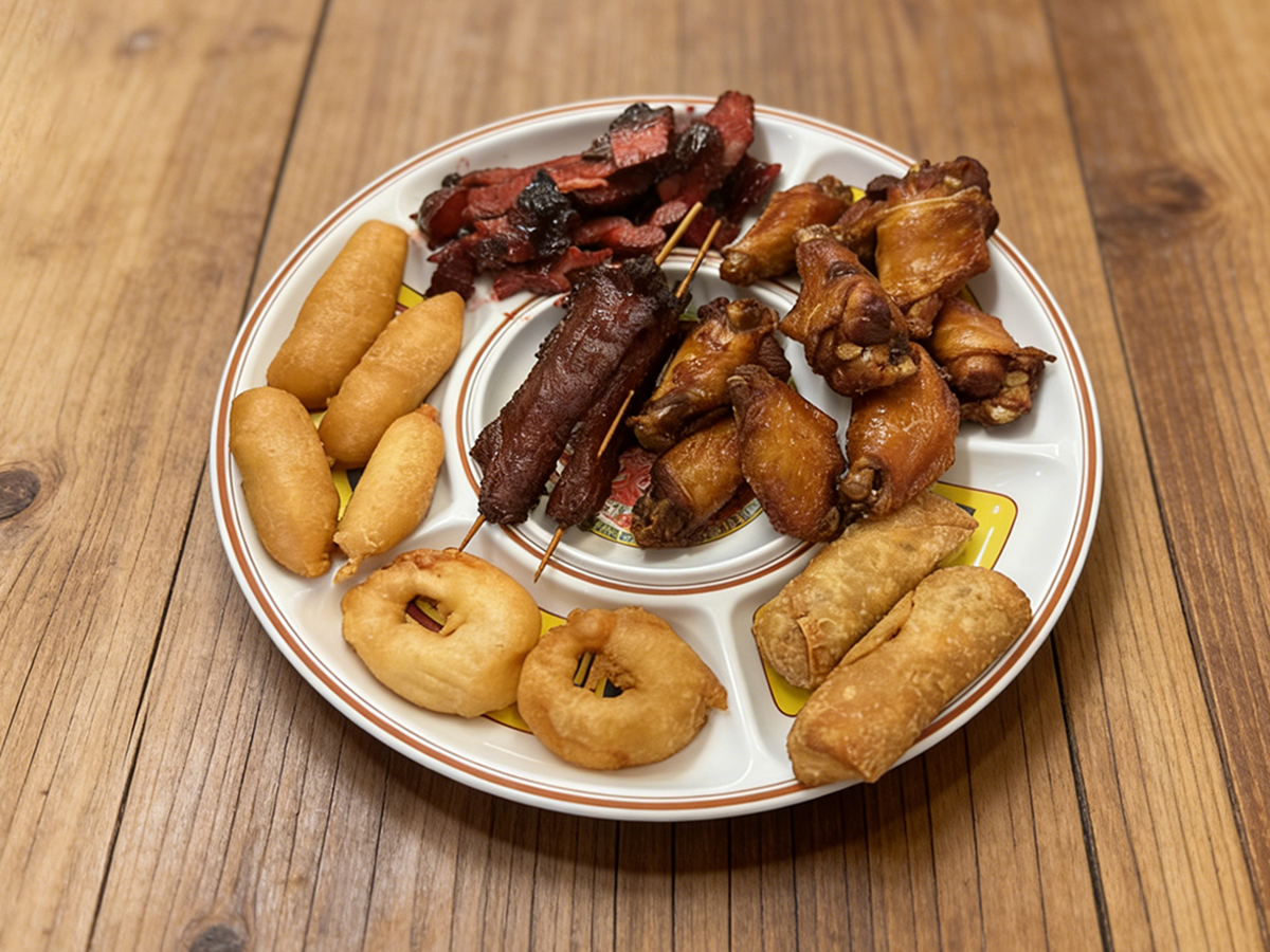 Chinese appetizer platter with chicken wings, skewers, and fried dough at Ming's Garden, a Chinese Restaurant in Bucksport