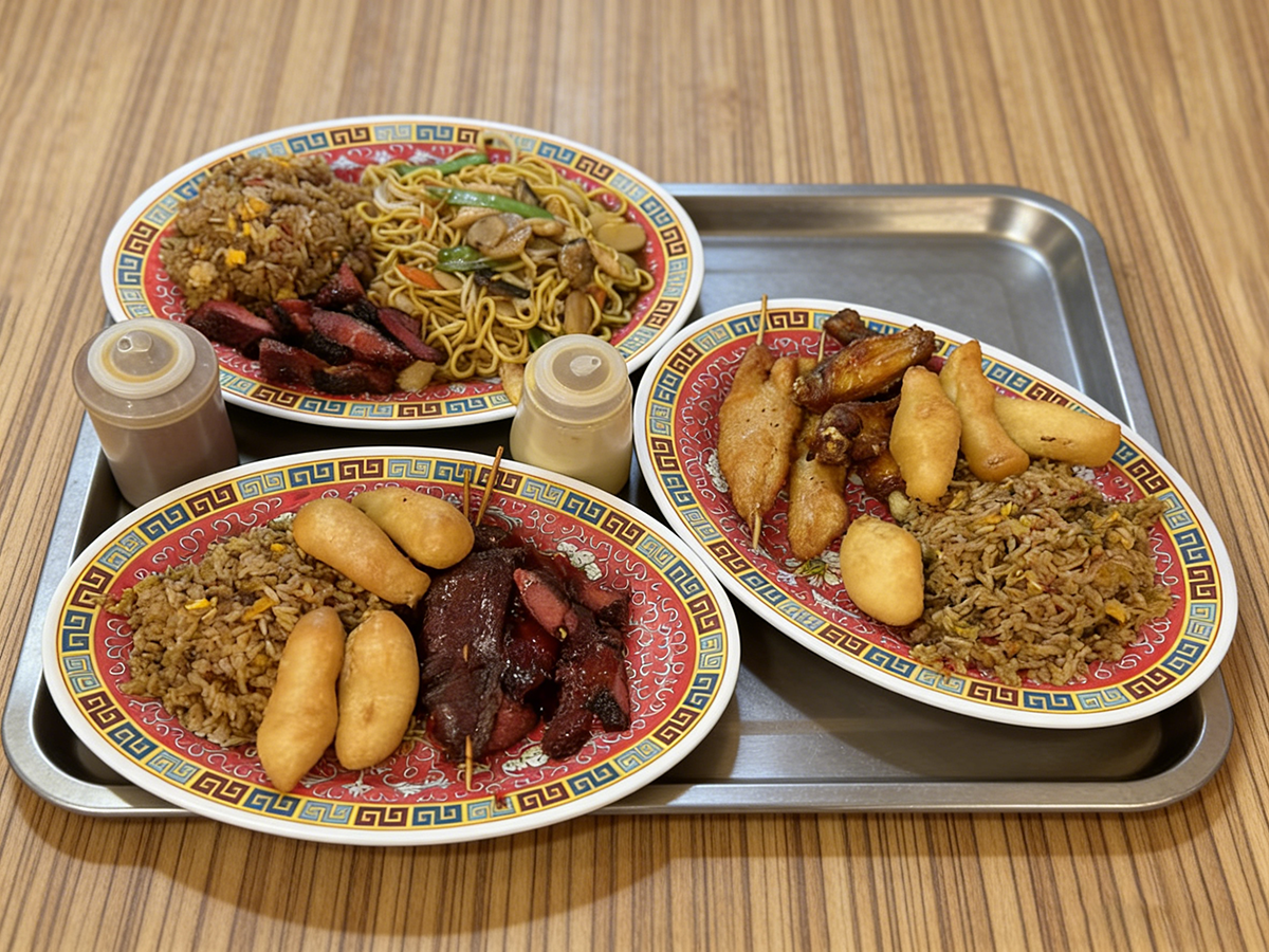 Assorted Chinese takeout platter with fried rice, noodles, and skewers at Ming's Garden, a Chinese Restaurant in Bucksport