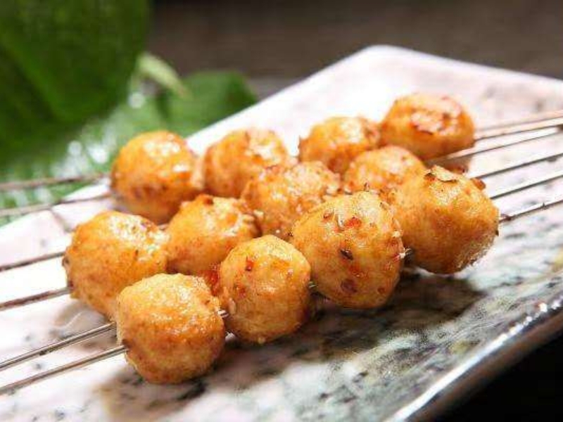 Grilled fish ball skewers with spicy seasoning at Pearl BBQ: Chinese Food Truck, a Chinese Restaurant in Elmhurst