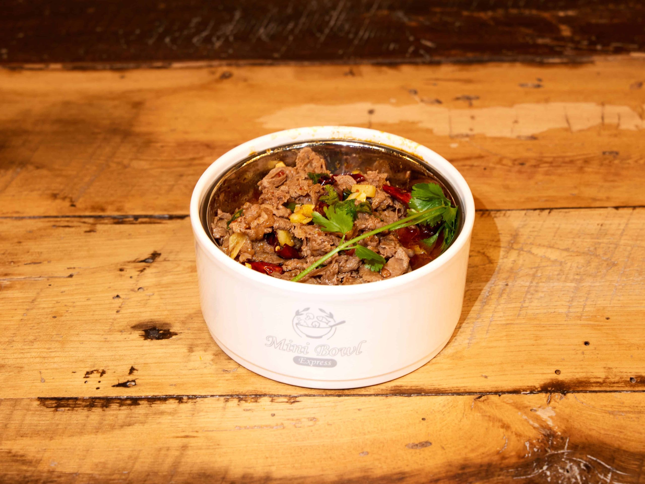 Tender beef in Sichuan chili sauce with cilantro at Mini Bowl Express, a Chinese Restaurant in Loma Linda