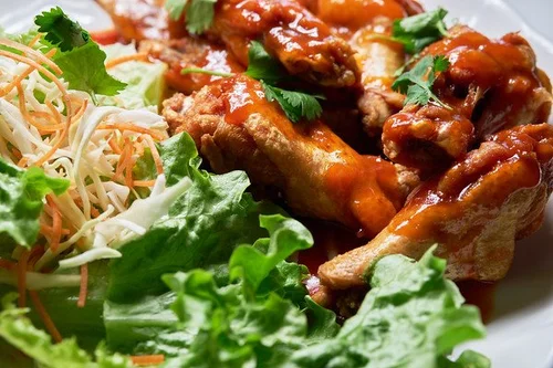 Fresh salad greens topped with teriyaki - glazed chicken pieces at Mint Bistro，a Asian Fusion Restaurant in Milford