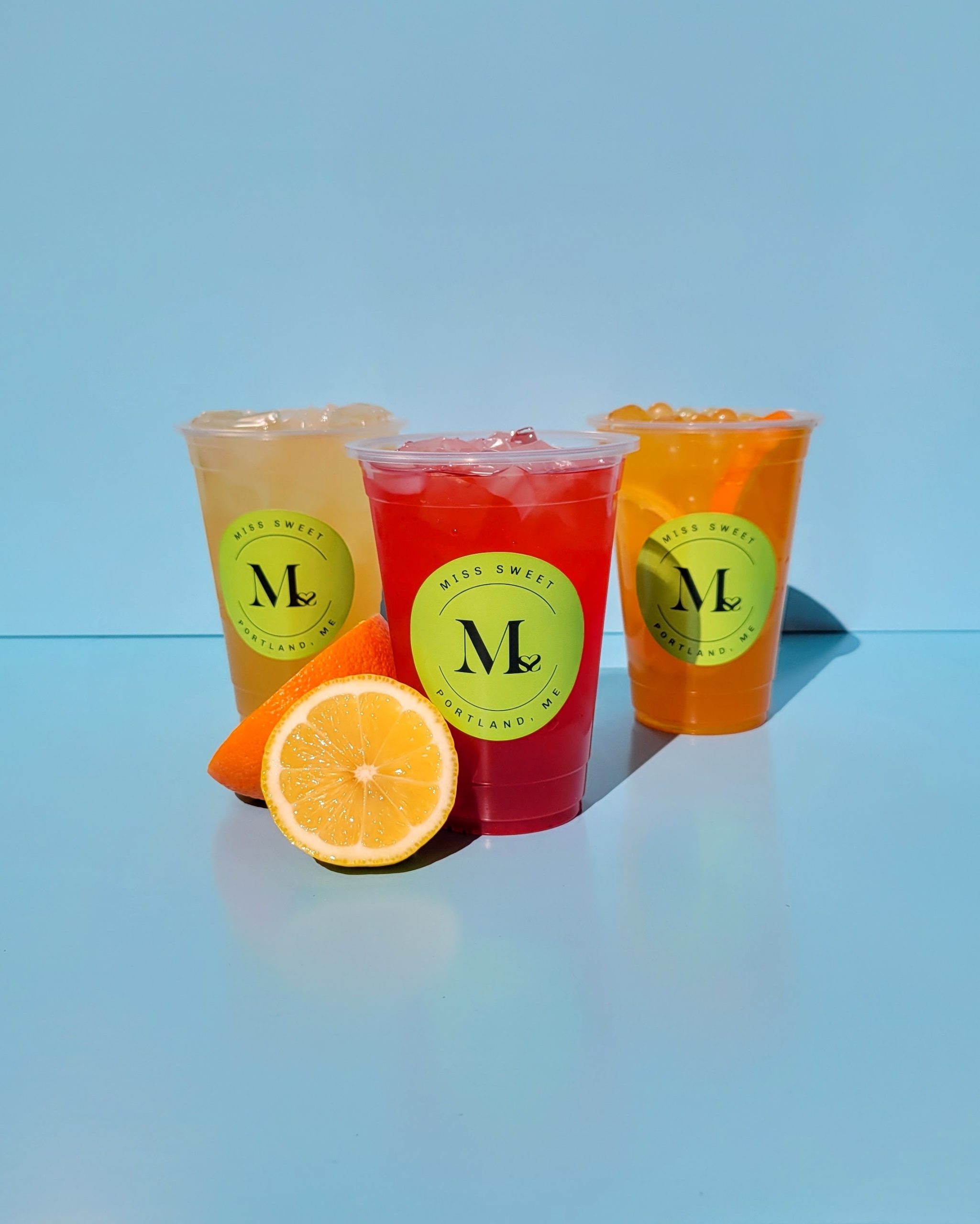 Miss-Sweet-Bubble-Tea-Store-Fruit-Tea-Drinks-Portland Assorted fruit tea drinks with fresh citrus slices at Miss Sweet Bubble Tea Store in Portland