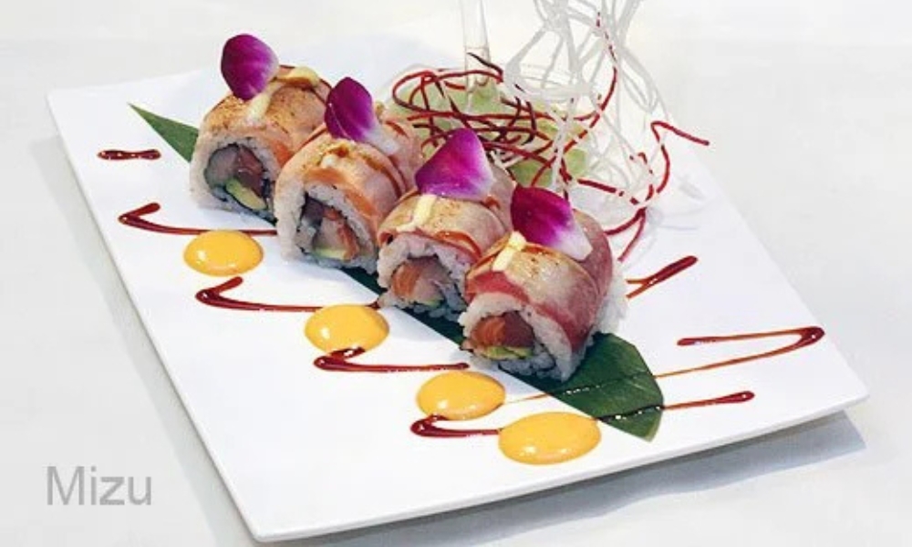 Creamy sushi roll topped with sauce and orchid at Mizu Japanese Restaurant, a Japanese Restaurant in Winston-Salem