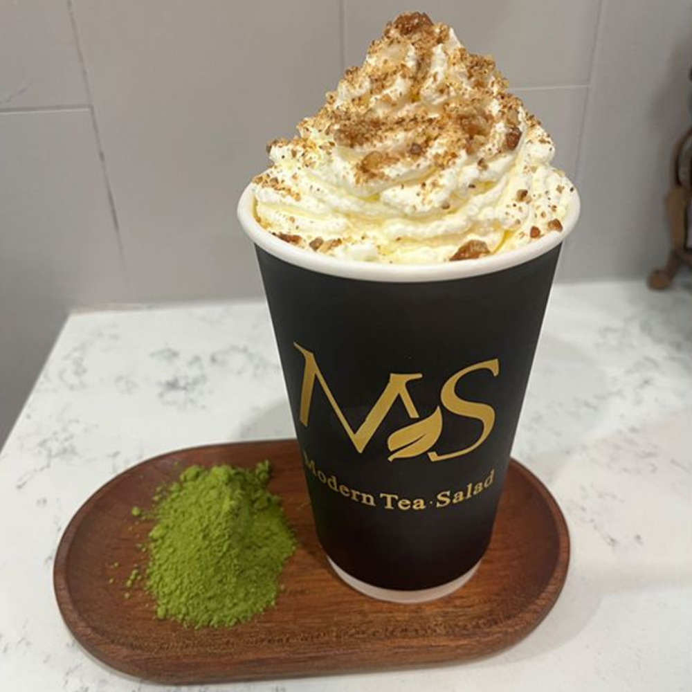 Matcha latte topped with whipped cream at Modern Tea・Salad, Salad shop in New York