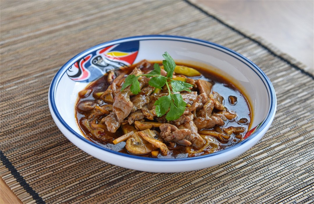 Spicy beef soup with mushrooms, garnished with cilantro at Moon Star, a Chinese Restaurant in Flushing