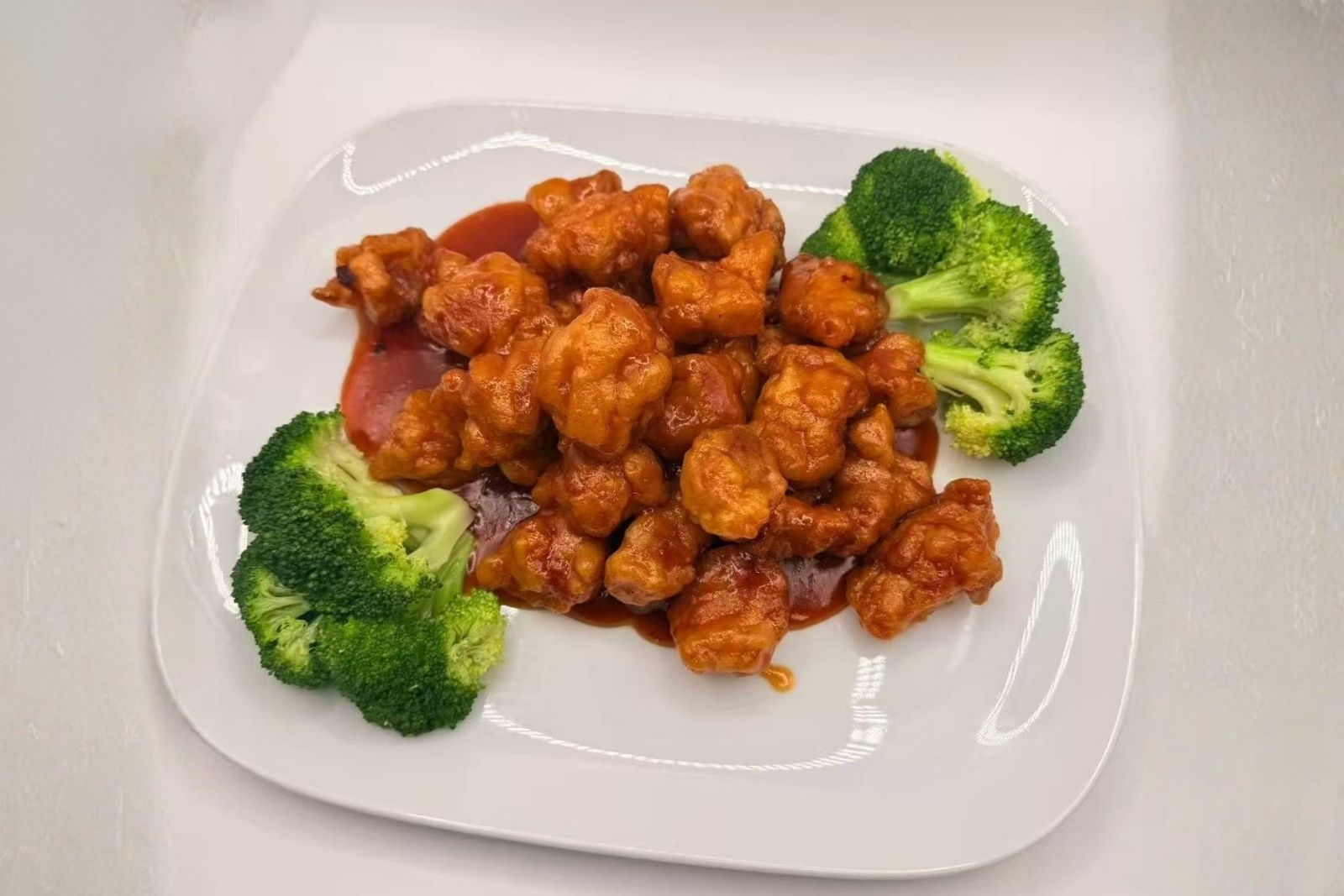 Sweet-and-sour chicken served with broccoli at Mr Boba Kitchen , a Asian Fusion Restaurant in New Windsor