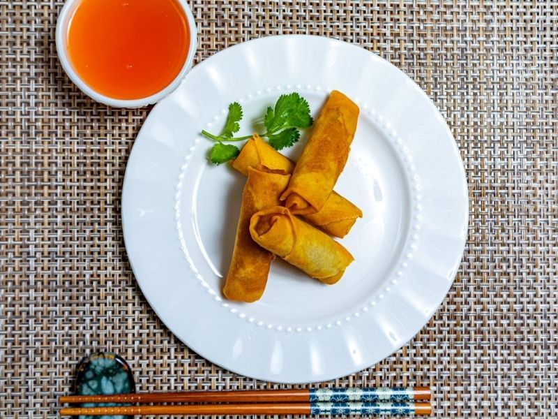 Golden fried spring rolls with cilantro garnish at Mr.Hibachi Japanese Grill, a Japanese Restaurant in Dover